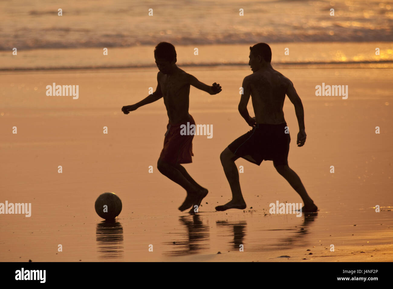 El Salvador, Playa San Blowing, silhouette, men, young, go in for football, sundown, Stock Photo