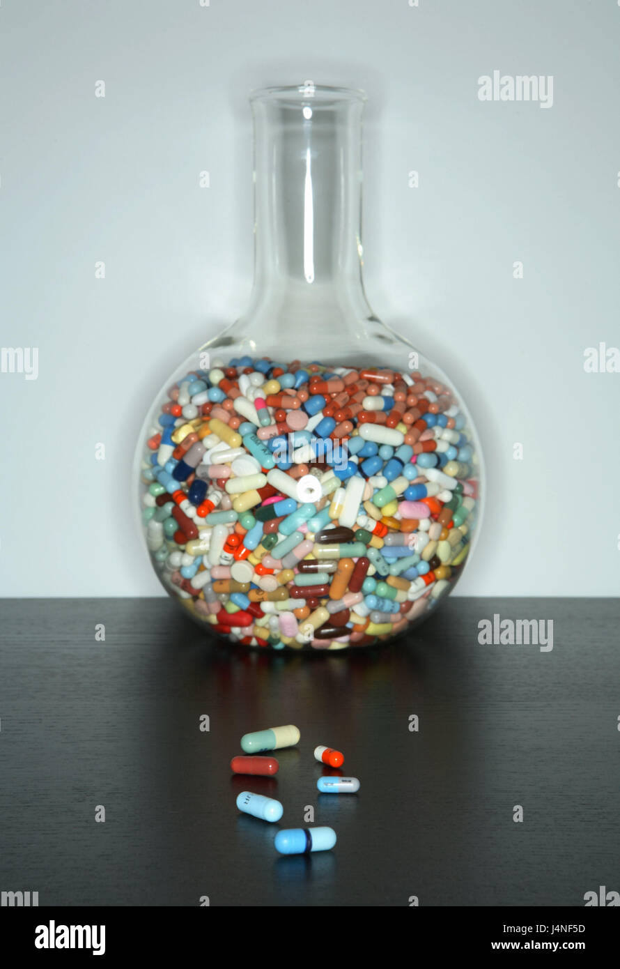 Glass flask, drugs, mixes, scatters, table, vessel, glass vessel, glass case, flask, laboratory vessel, standing flasks, stuffed, completely, Pharmazeutika, the pills, capsules, tablets, dragée, brightly, passed away, differently, huge number, choice, original preparations, generic medicaments, in a mess, merged, tablet cocktail, drug cocktail, disease, healing, treatment, mark drug, inside, Stock Photo