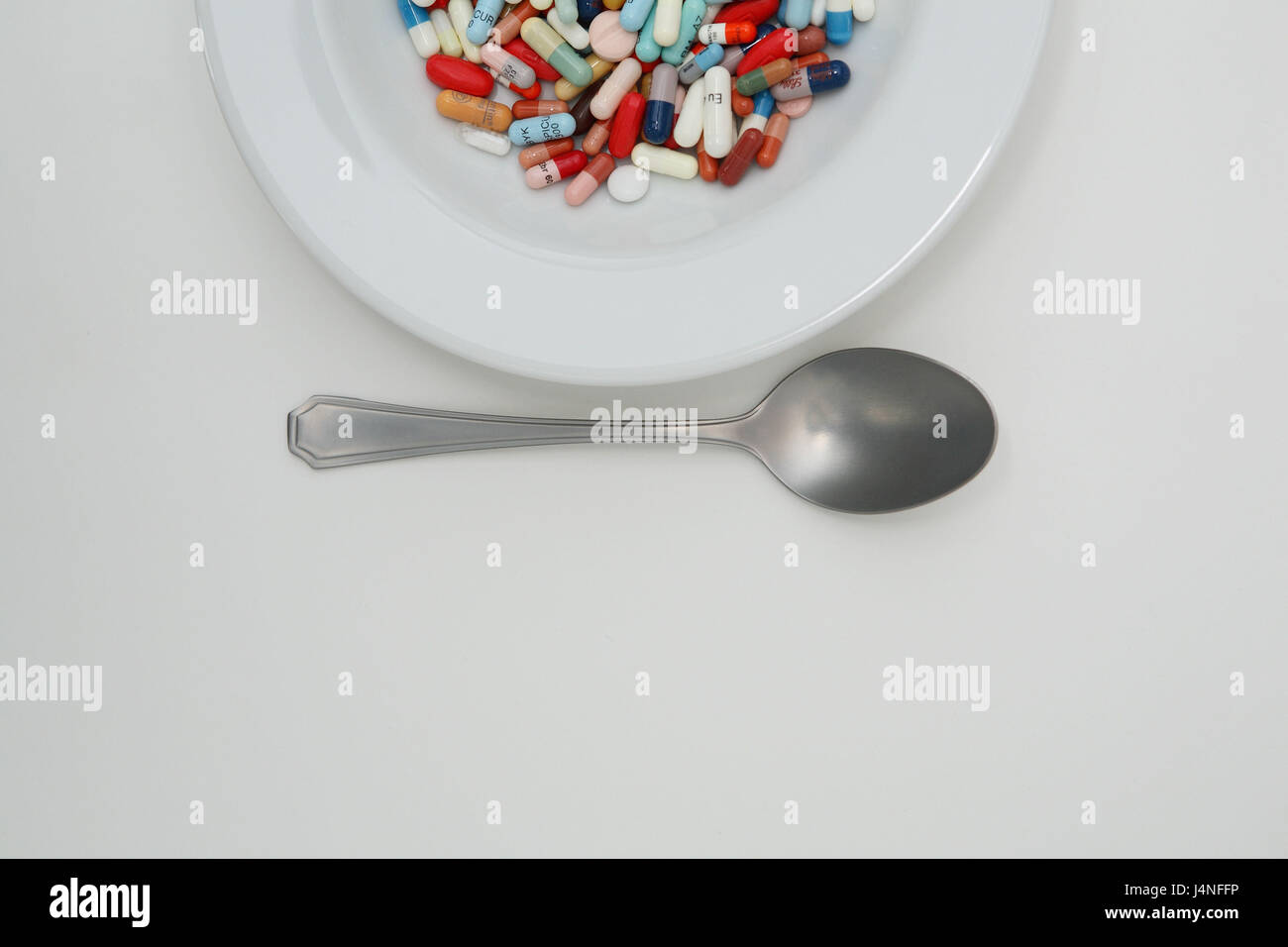 Drugs, plates, tablets, capsules, spoon, curled, Stock Photo