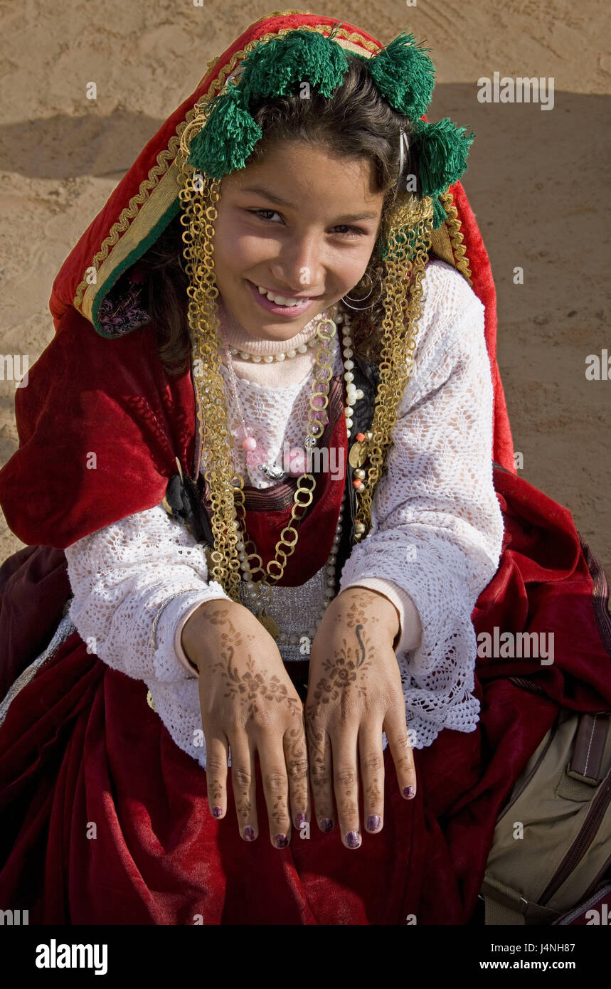 Tunisia, Douz, Sahara festival, Berber girl, hands, paints, traditionally, North Africa, Sahara, festival, feast, event, oasis town, desert, person, locals, tribe, Berber, girl, young, woman, smile, point, clothes, jewellery, folklore, ornaments, painting, back of the hand, tradition, culture, Stock Photo