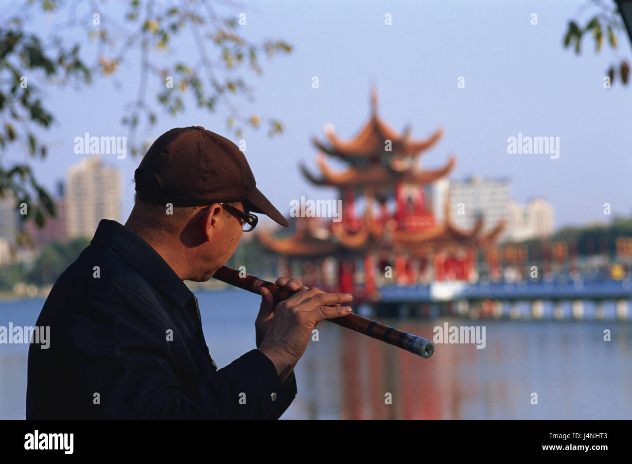 Taiwan, Kaohsiung, Lotos lake, man, flute, play, back view, blur, no model release, Asia, destination, place of interest, Taoism, temple, person, Asian, leisure time, headgear, glasses, music, musical instrument, play on the flute, transverse flute, melody, détente, Stock Photo