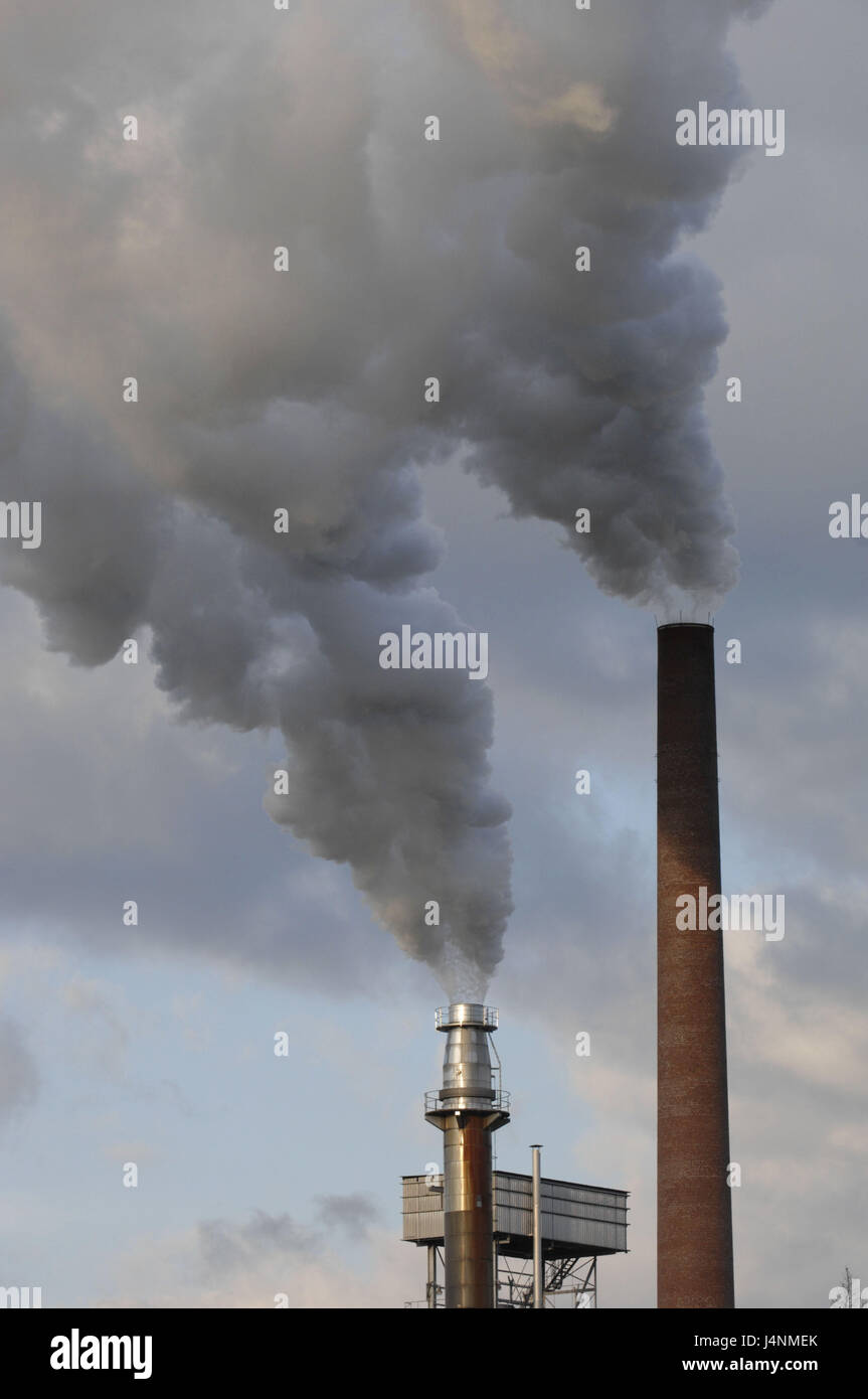 Industrial attachment, chimneys, smoke, cloudy sky Stock Photo - Alamy