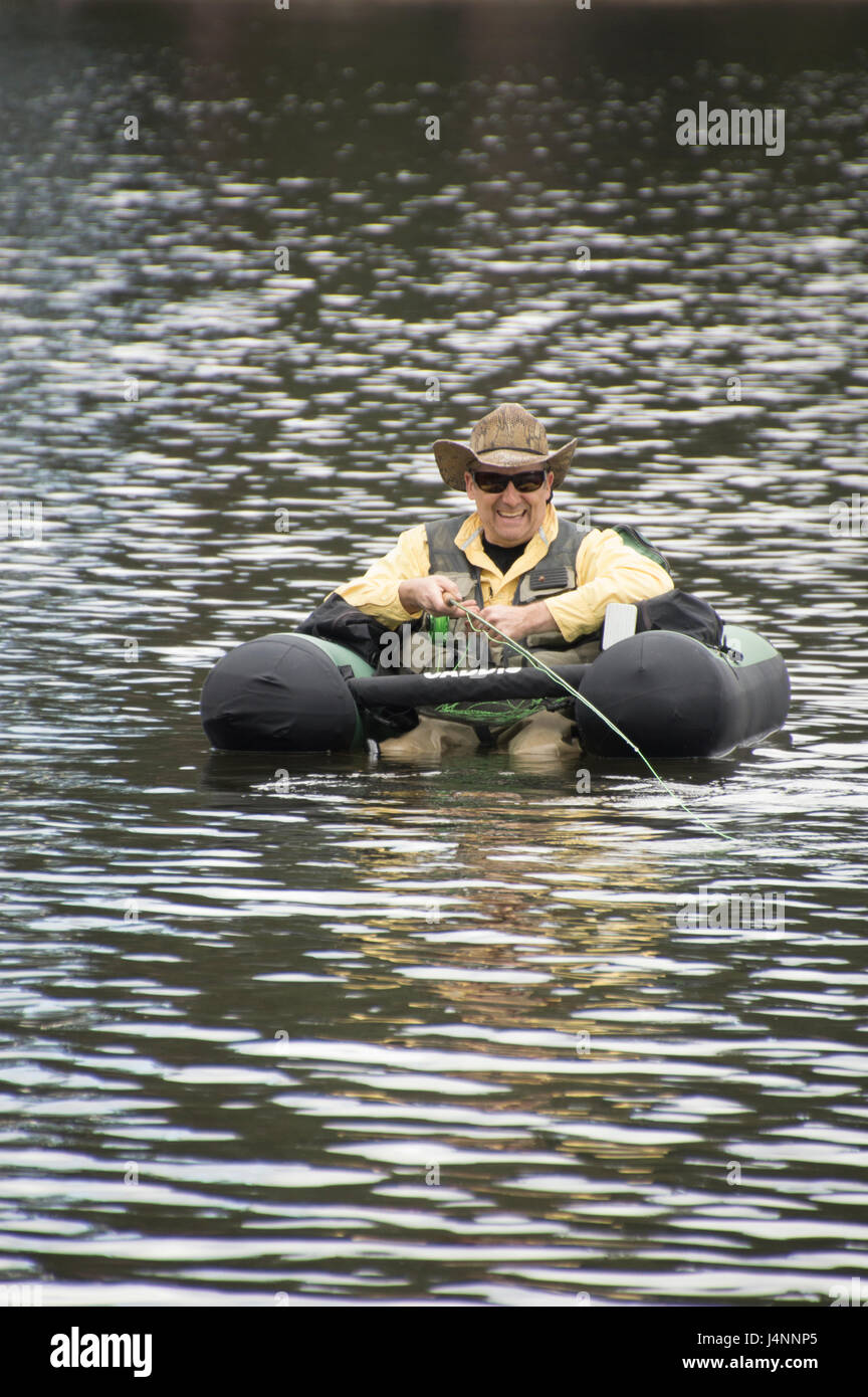 Fisherman in a float tube fly fishing for trout near Sand Point, Idaho. Stock Photo