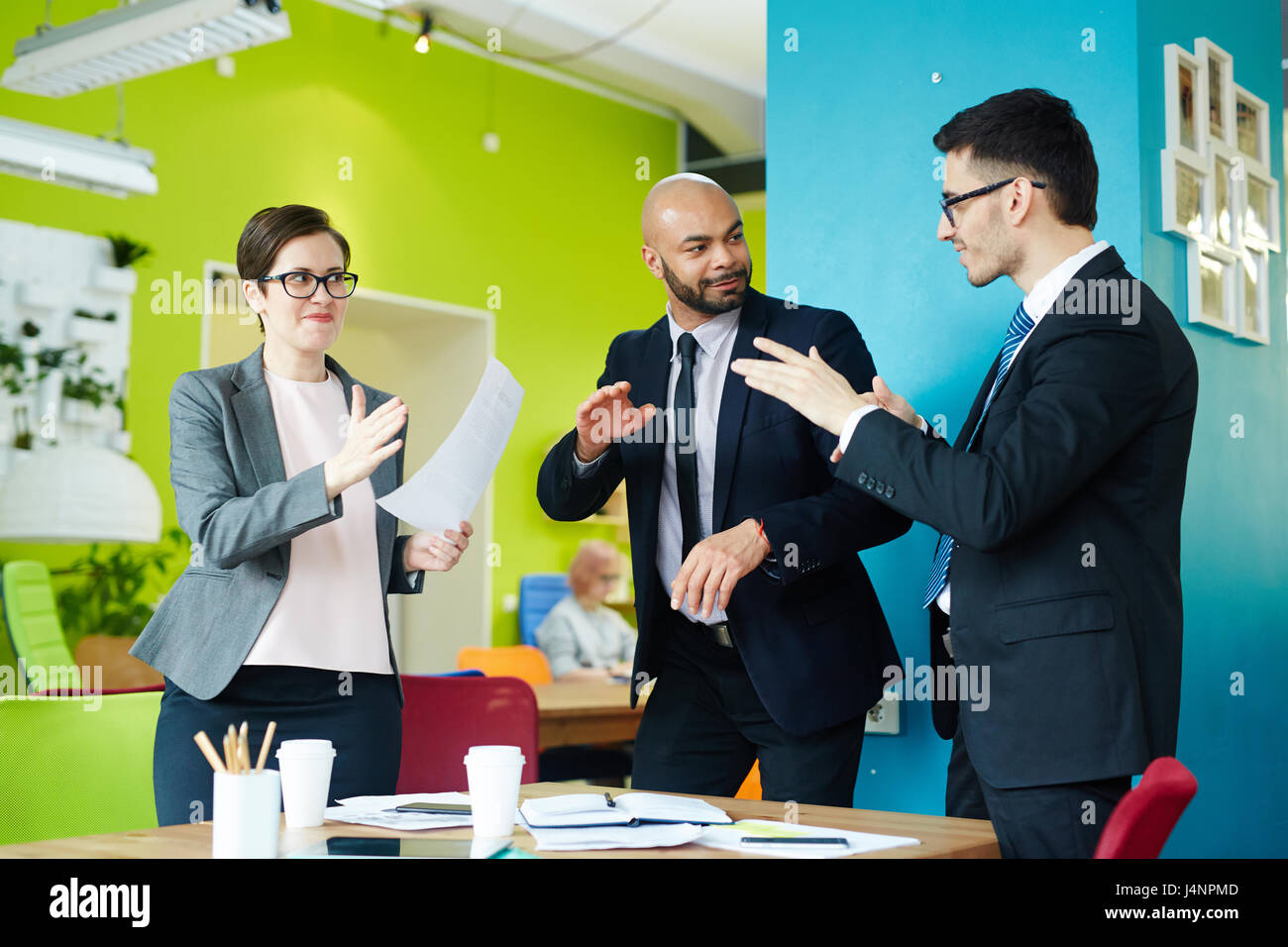 Energetic co-workers dancing in studio at break Stock Photo