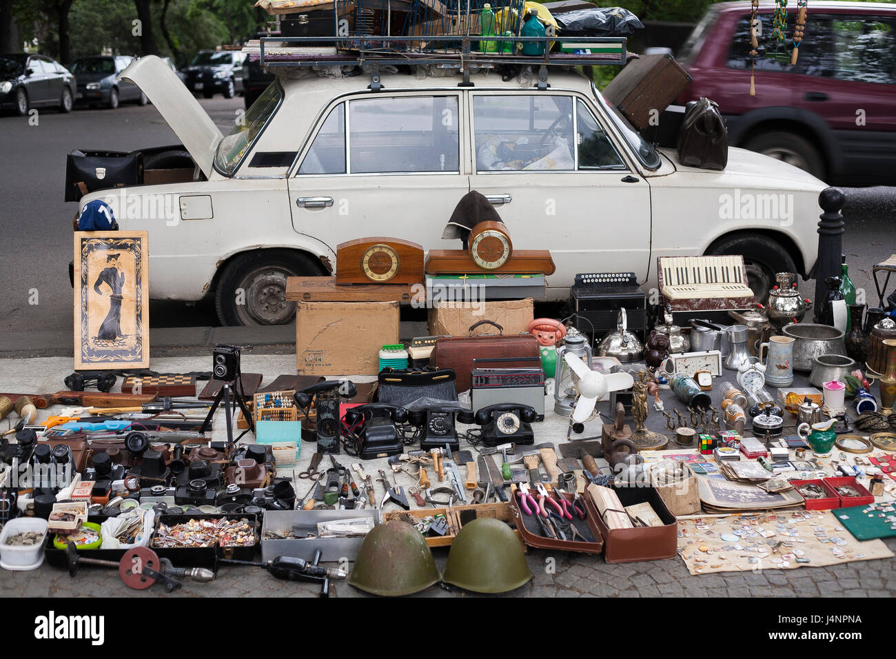 Goods displayed on a Lada car and the pavement at the weekly Dry Bridge Market flea market in Central Tbilisi, Georgia Stock Photo