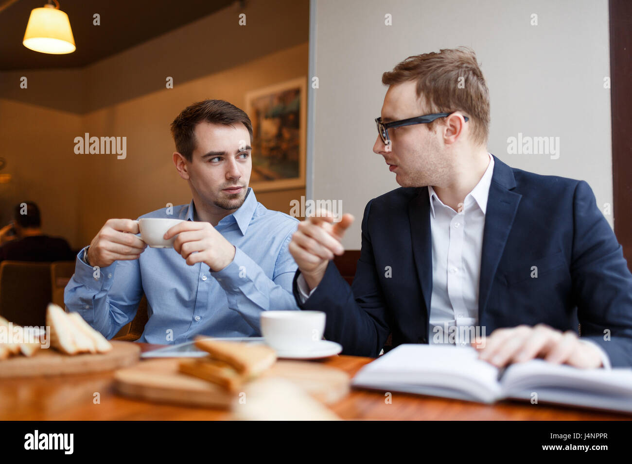 Two people talking serious cafe hi-res stock photography and images - Alamy