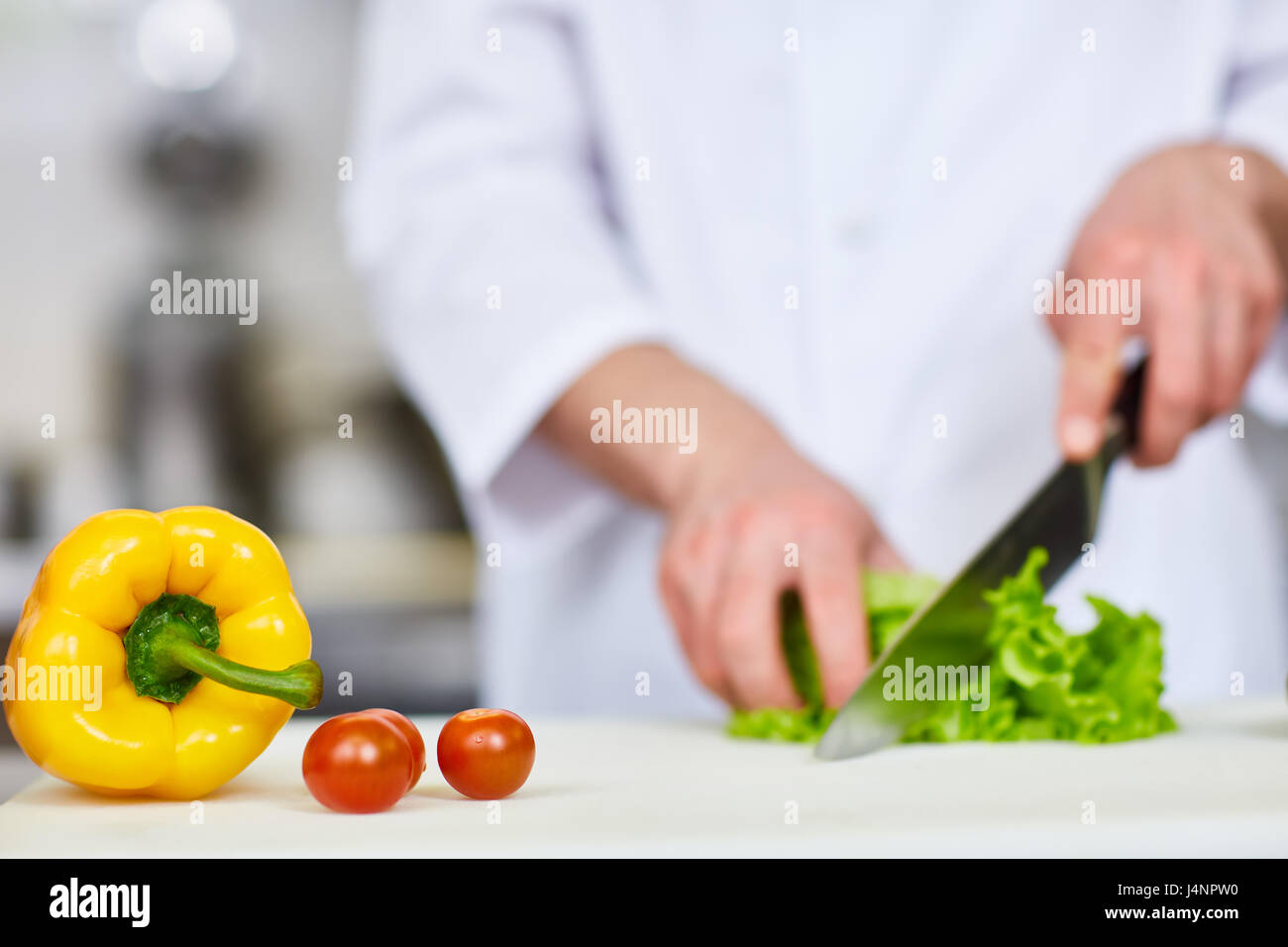 Gresh yellow pepper and ripe tomatoes on workplace of chef Stock Photo