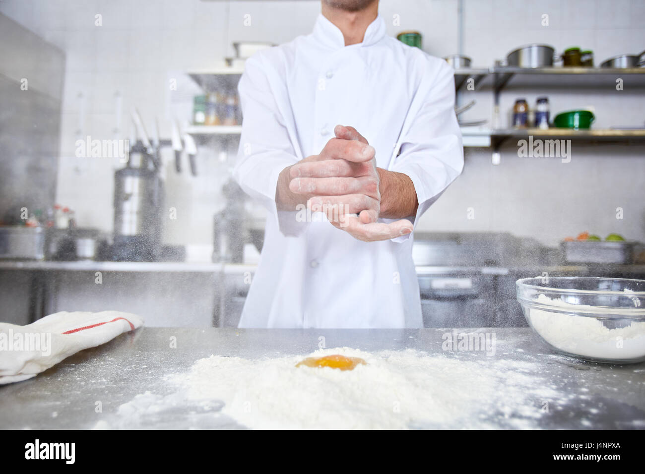 Chef keeping his hands over table with flour Stock Photo - Alamy