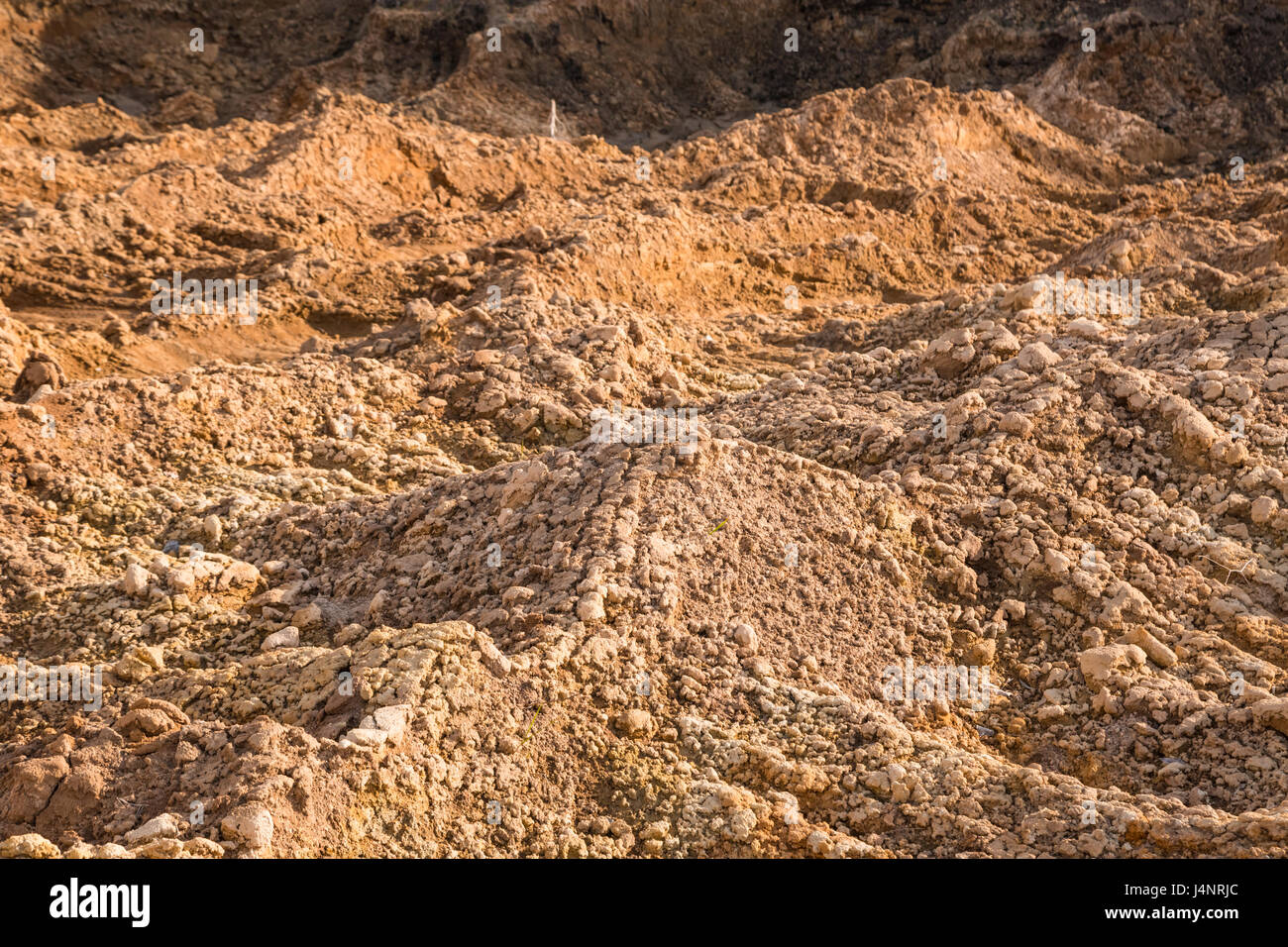 Clay and sand in the quarry. Beautiful unusual background similar to the surface of the planet Mars or the moon Stock Photo