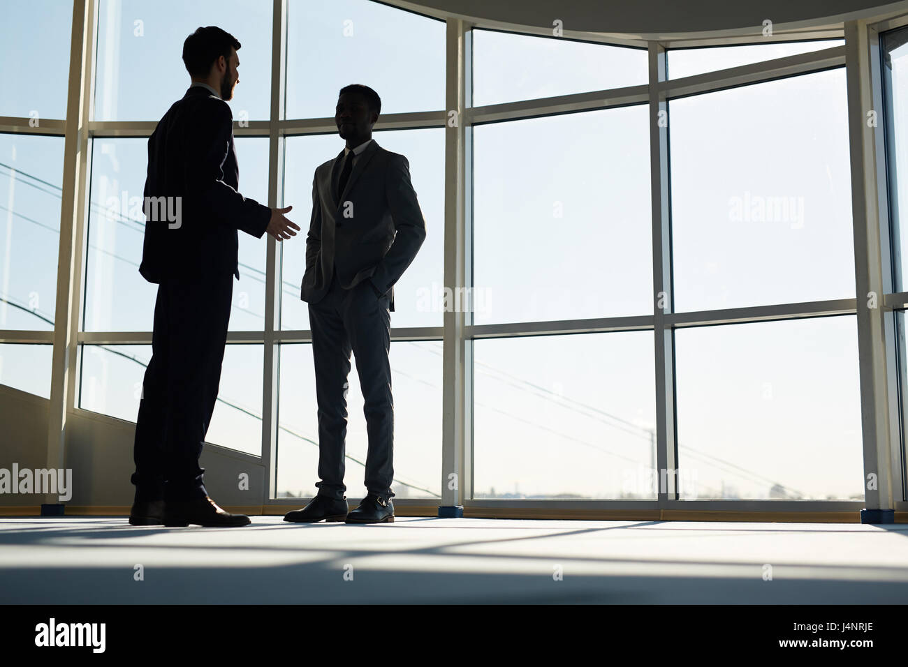 Young entrepreneurs discussing business ideas in office Stock Photo - Alamy