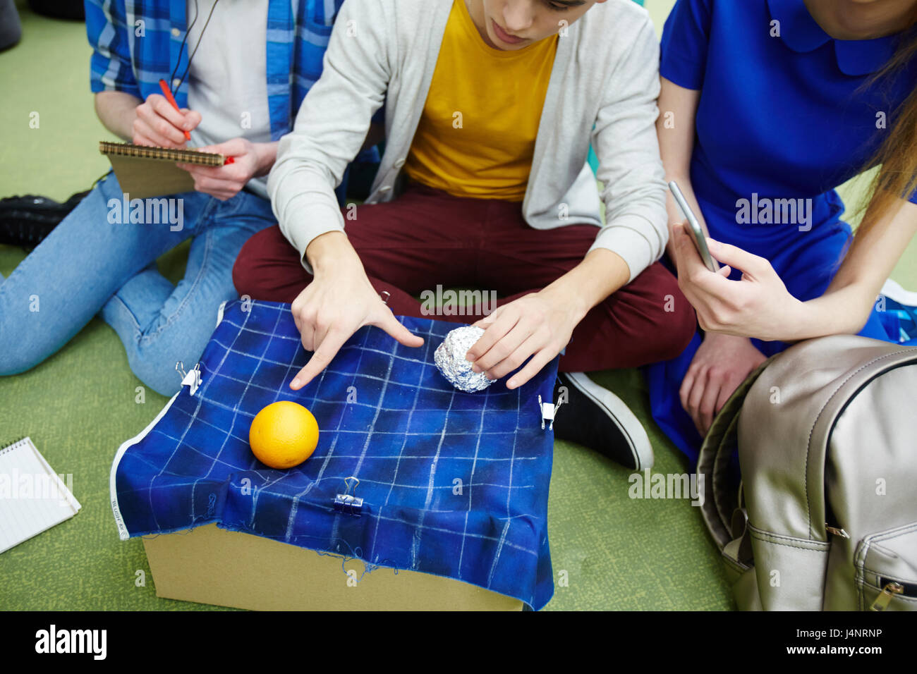 Clever student explaining his groupmates principle of physical rule