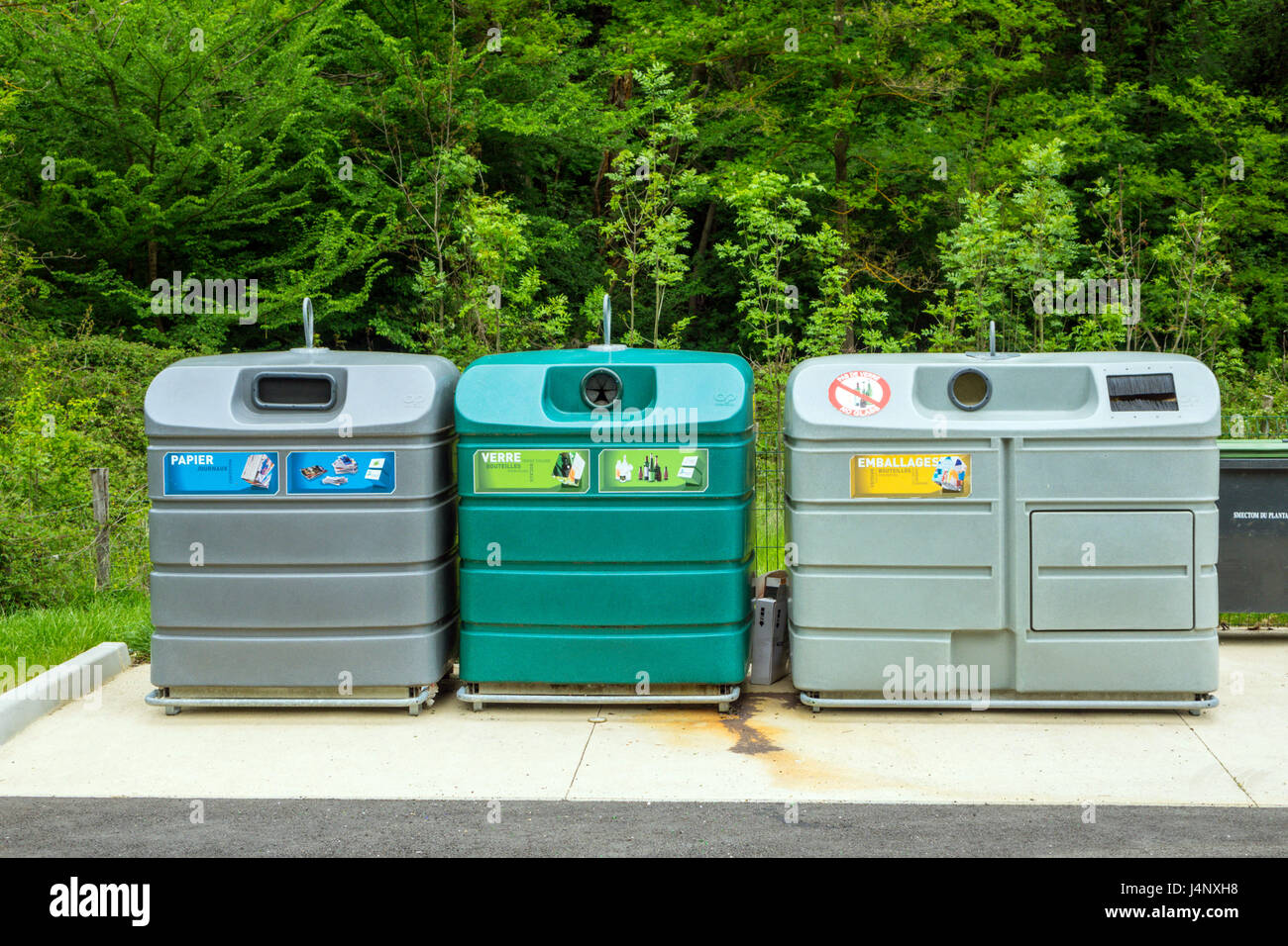 Large coloured recycling bins for glass paper and packaging Stock Photo