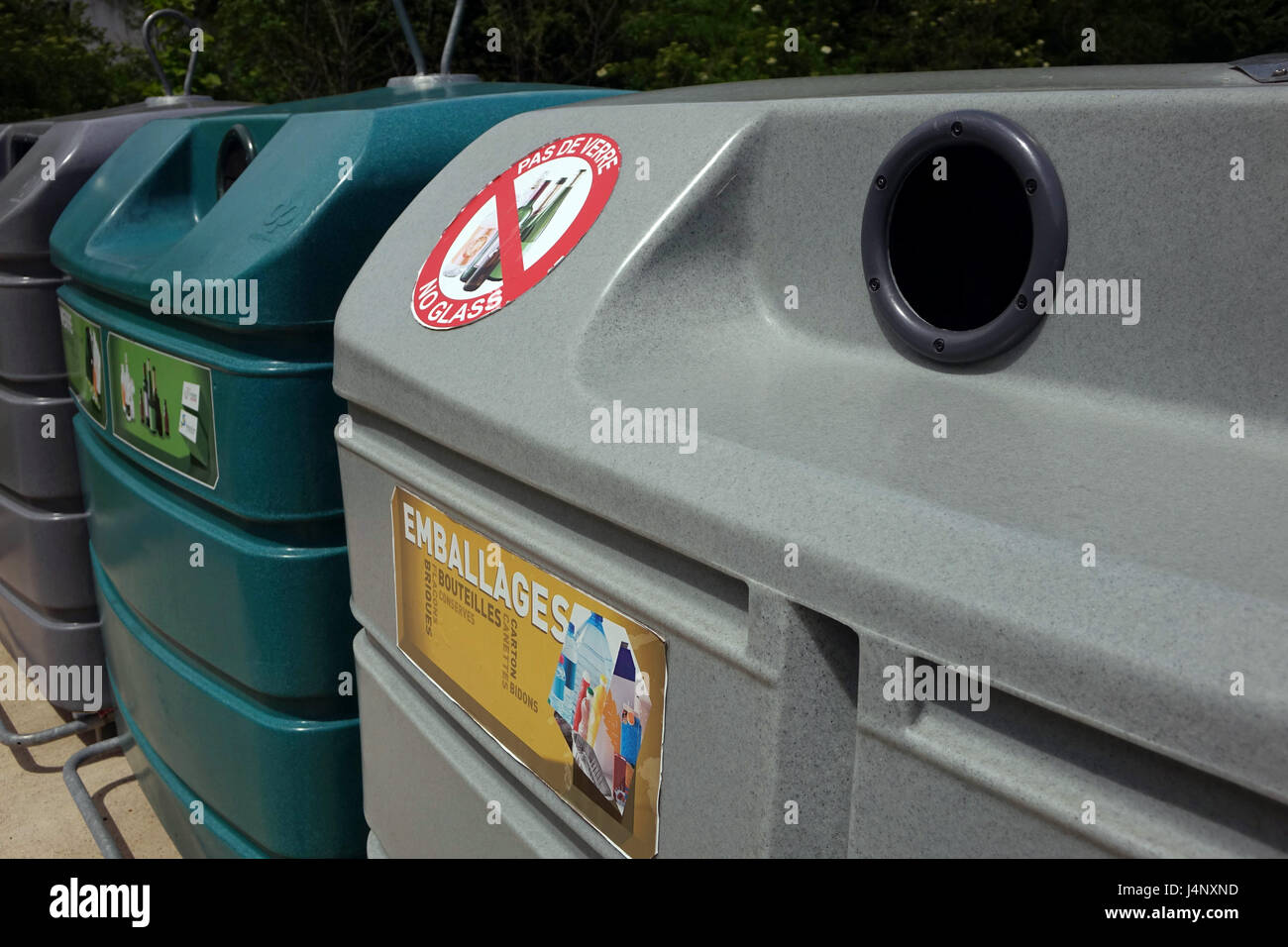 Large coloured recycling bins for glass paper and packaging Stock Photo