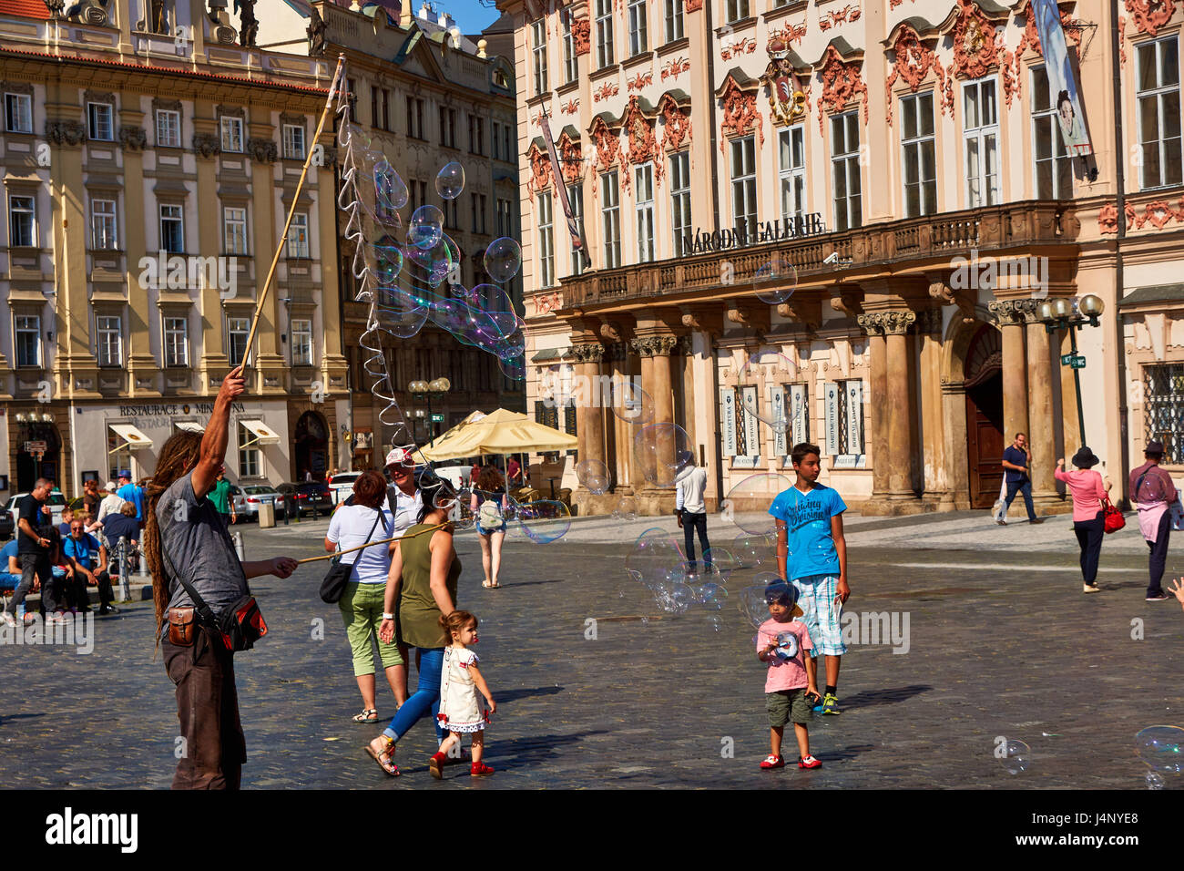 Street artist makes soap bubbles on the Old Town Square in Prague, Czechia Stock Photo