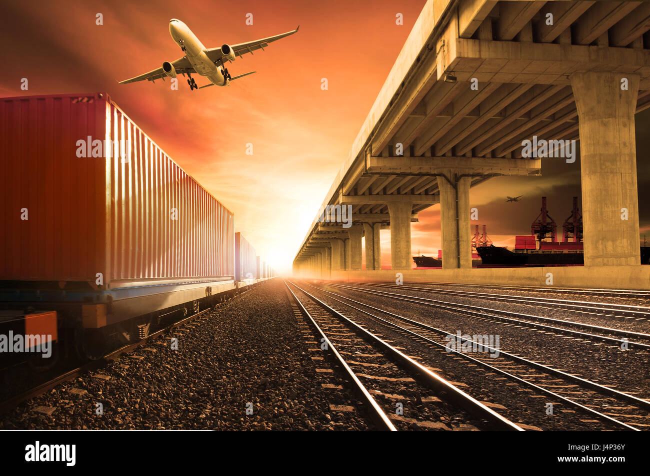 industry container trains running on railways track  cargo plane flying with land bridge transportation over ship port use for land ,air and ship tran Stock Photo