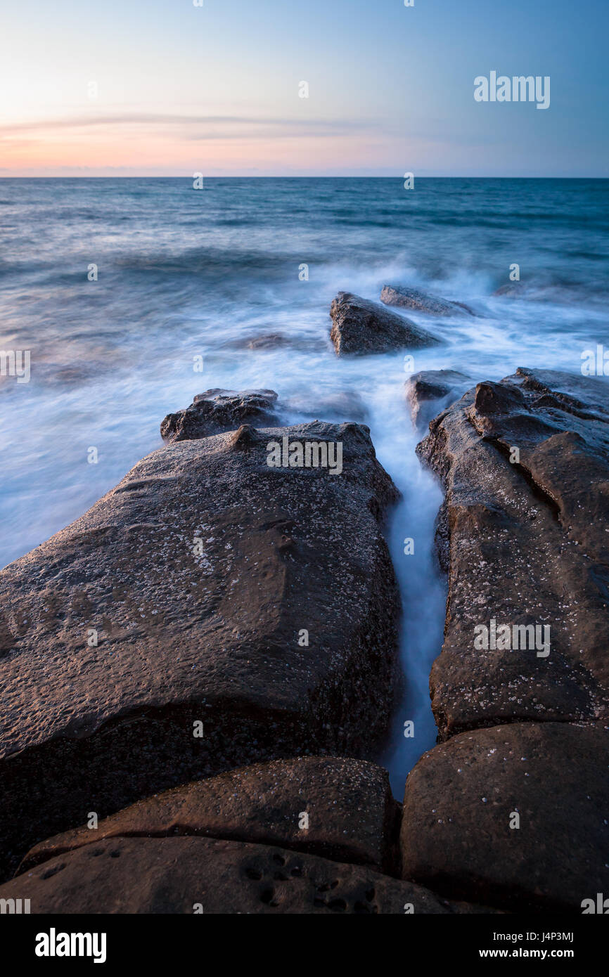 Waves and rocks shore long exposure Stock Photo - Alamy