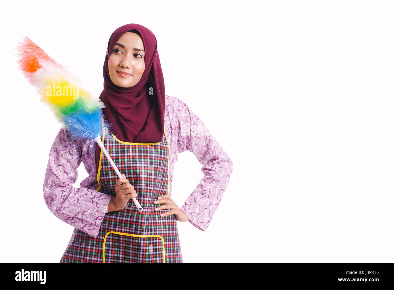 Portrait of housewife wearing an apron and hold a cleaning tool isolated on white background - cleaning concept Stock Photo