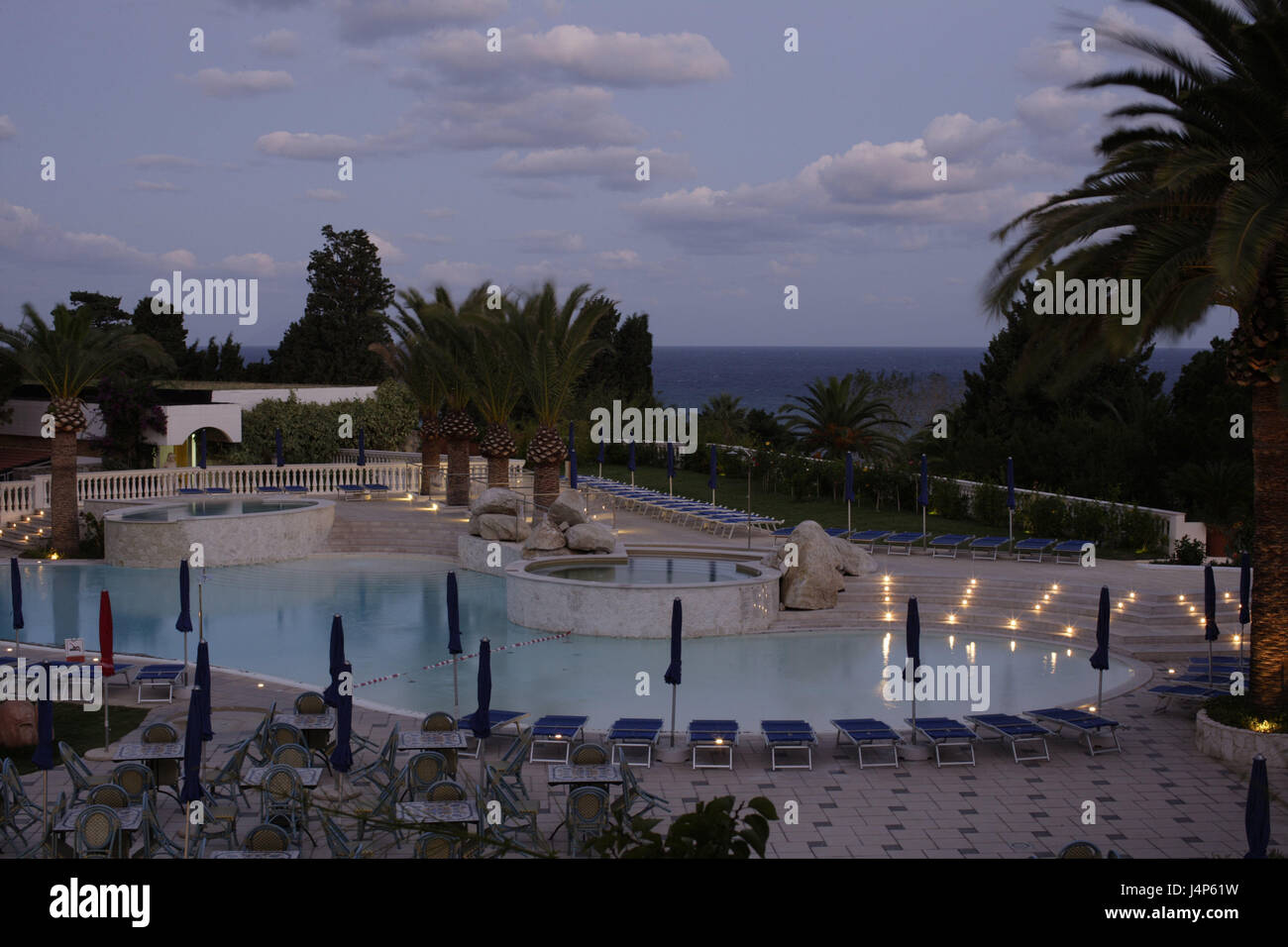 Italy, Calabria, Tropea, hotel Rocca Nettuno, pool attachment, dusk, Süditalien, hotel facility, pool, swimming pool, palms, deck chairs, vacation, beach holiday, summer vacation, travel destination, tourism, evening tuning, Stock Photo