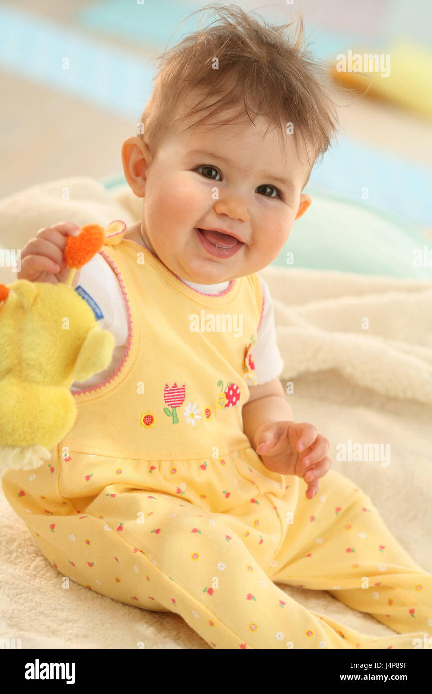 Baby, 10 months, sit, hold soft animal, model released, people, child, infant, dresses, dark-haired, Indoor, laugh, girls, toys, nonsense animal, body, Strampler, yellow, happily, sweetly, Stock Photo