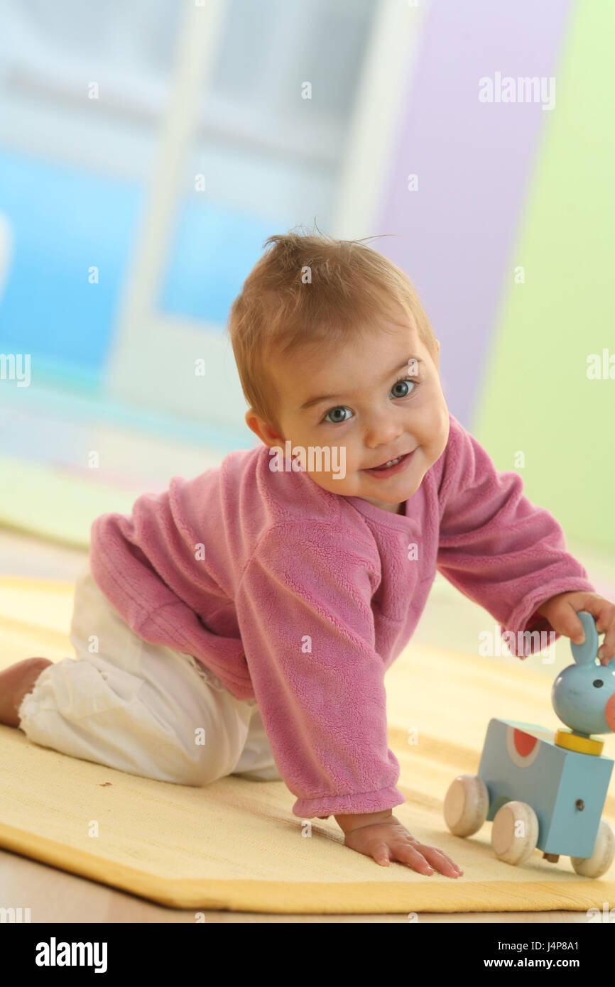 Baby, 9 months, creep, play, model released, people, child, infant, add support, dresses, dark-haired, discoveries, Indoor, learn, girls, toys, little cog, smile, Stock Photo