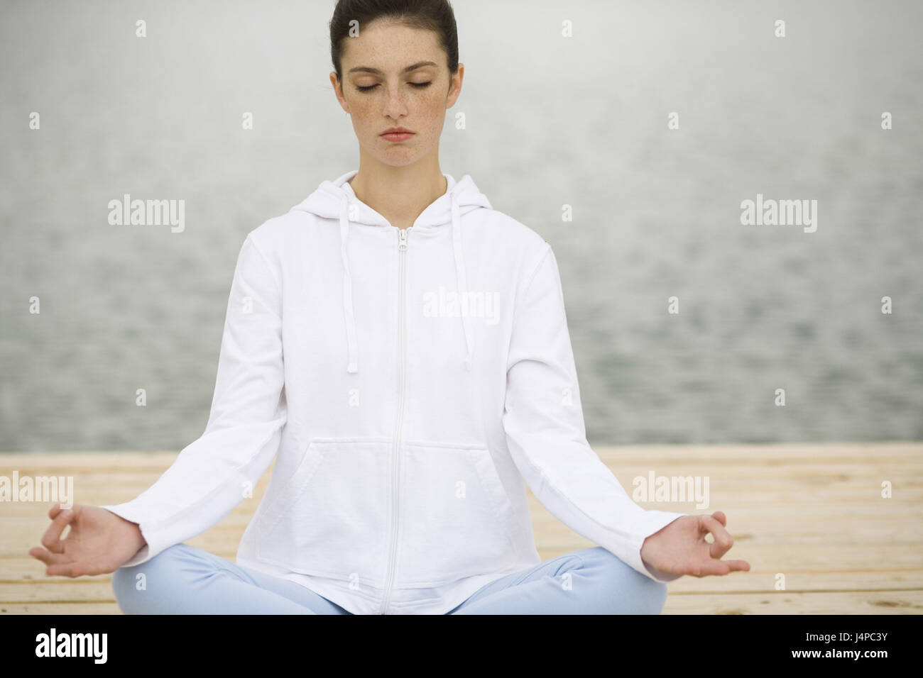 Woman, sit young, seriously, meditation, model released Stock Photo - Alamy
