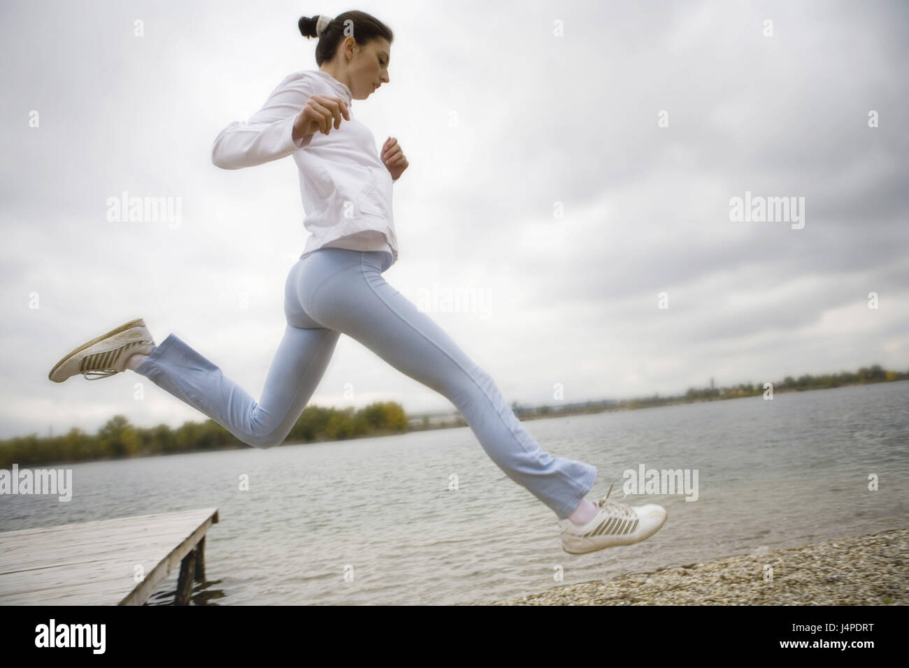 Woman, young, jog, lakeside, crack, at the side, model released, Stock Photo