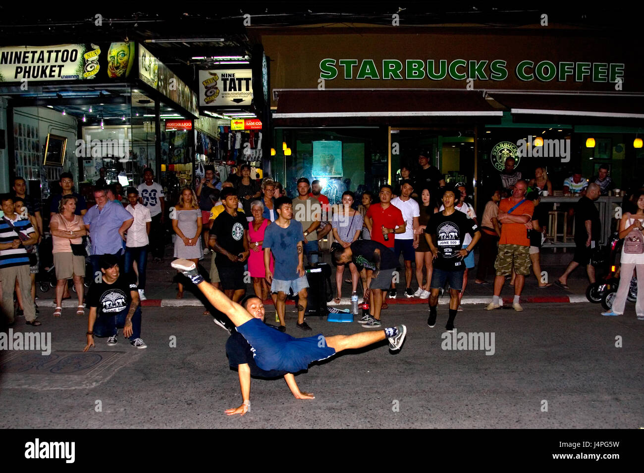 Phuket, Thailand, January 27, 2017: A young man dancing in front of the audience on Bangla Road. Stock Photo