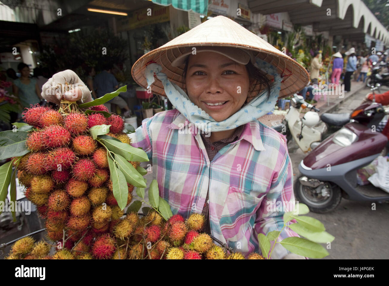 Vietnam, Ho Chi Minh Stadt, street shop assistant, fruits, Rambutan, no model release, Stock Photo