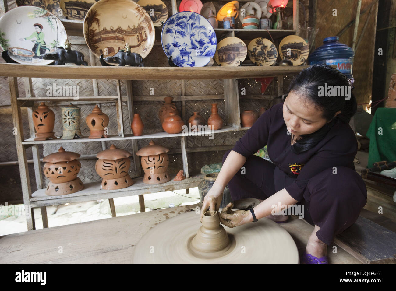 Vietnam, Hoi In, pottery, garage, woman, potter's wheel, no model release, Stock Photo