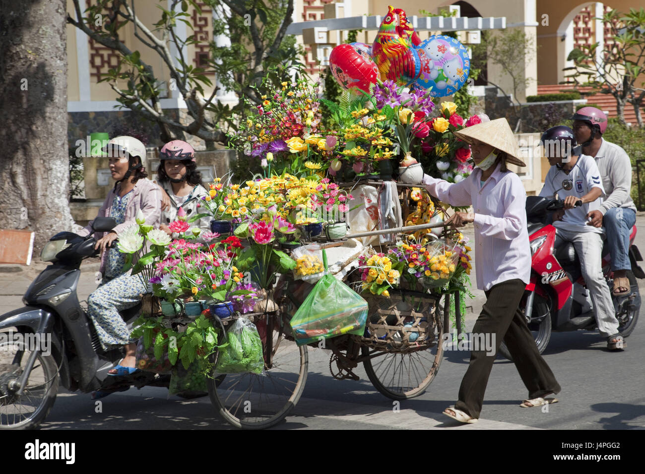 Vietnam, Hoi In, shop assistant, bicycle, artificial flowers, no model release, Stock Photo