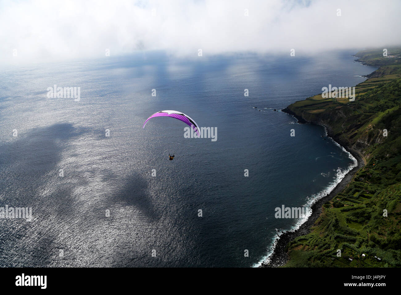 A paragliding pilot flying during the 22nd Azores Paragliding Festival