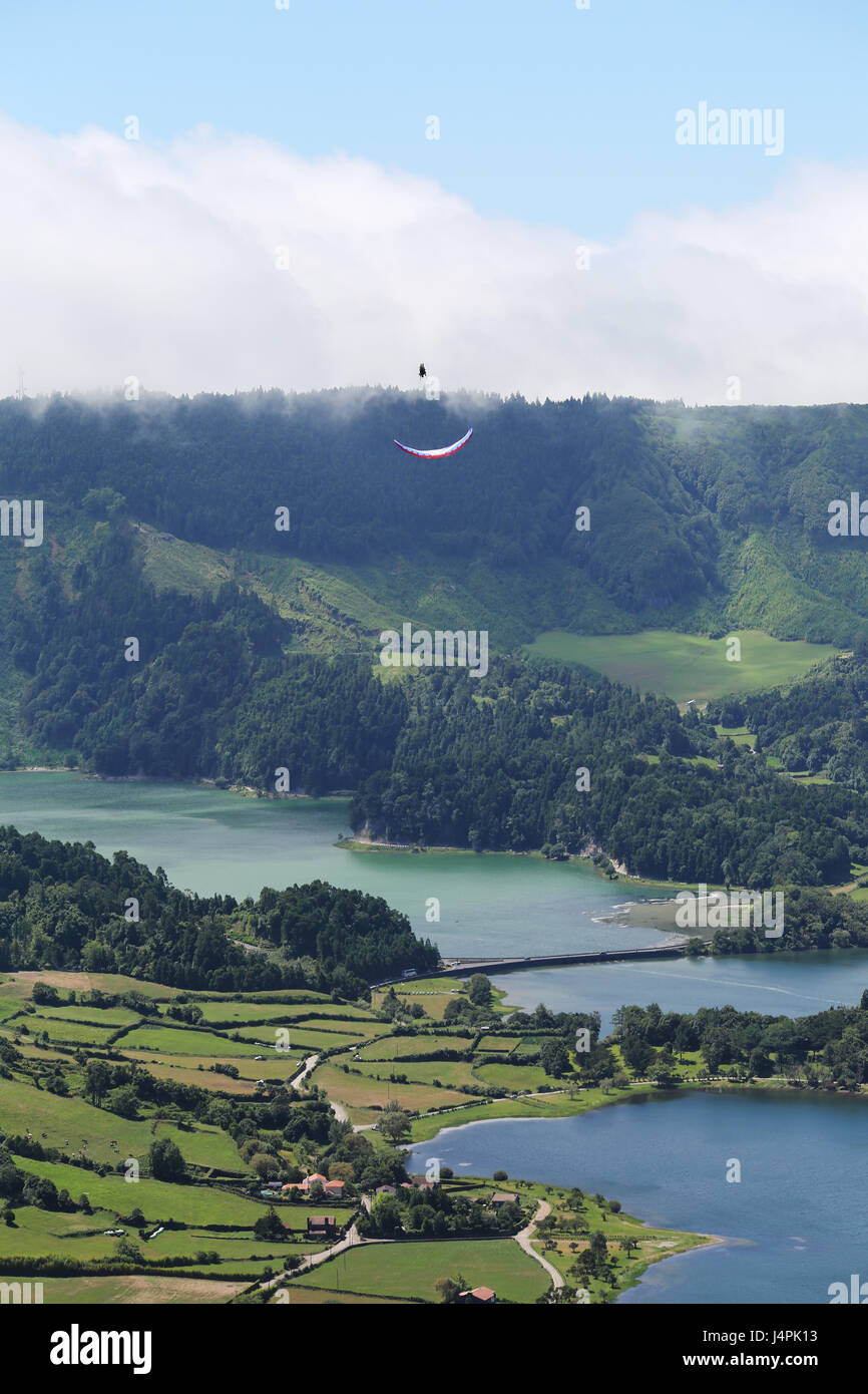 A paragliding acro pilot flying during the 22nd Azores Paragliding Festival at Lagoa das Sete Cidades in São Miguel, Azores, Portugal. Stock Photo