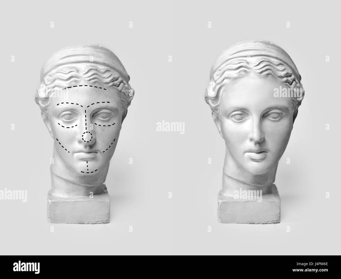 Two marble heads of young women, ancient Greek goddess bust marked with lines for plastic surgery and sculpture after operation on light background. Old and new beauty standarts concept. Stock Photo