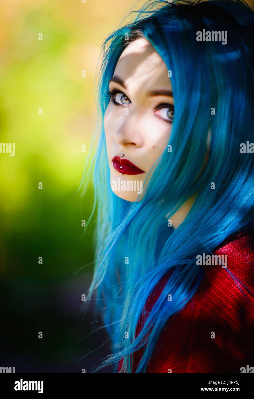 Close-up portrait of a pretty young girl with blue hair Stock Photo