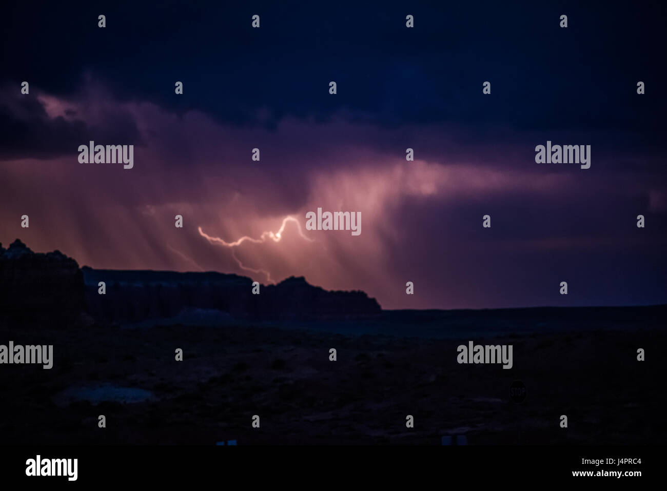 Night sky during the thunderstorm in the distance with canyons. Stock Photo