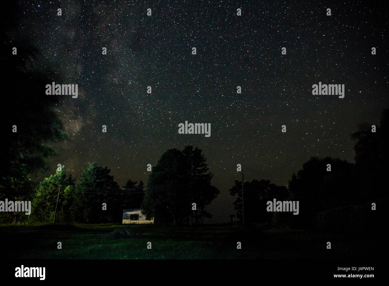 Night starry sky scene with illuminated cottage in the forest Stock ...