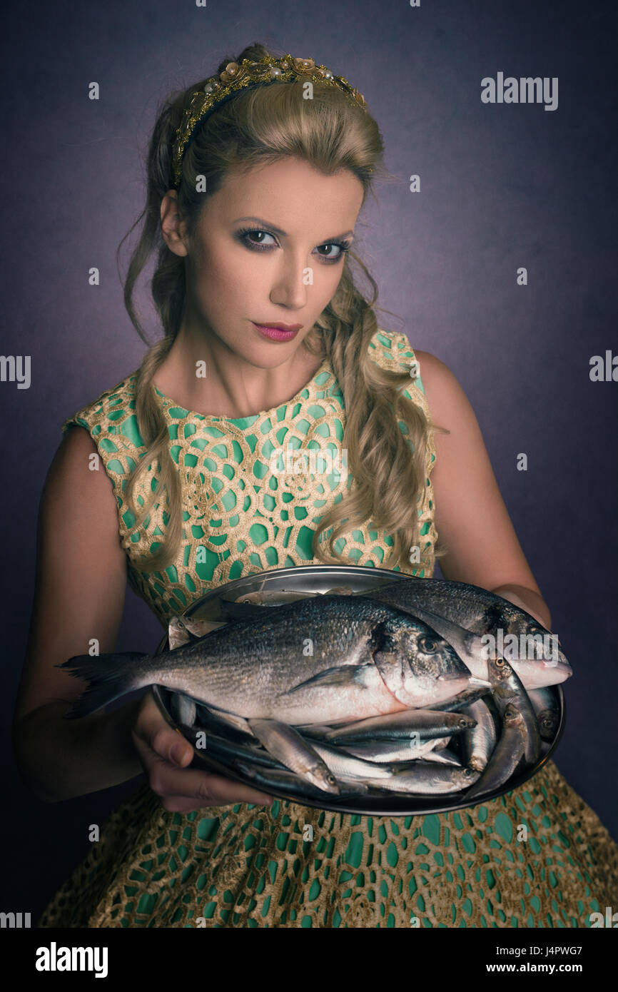 Beautiful woman serving fish Stock Photo Alamy