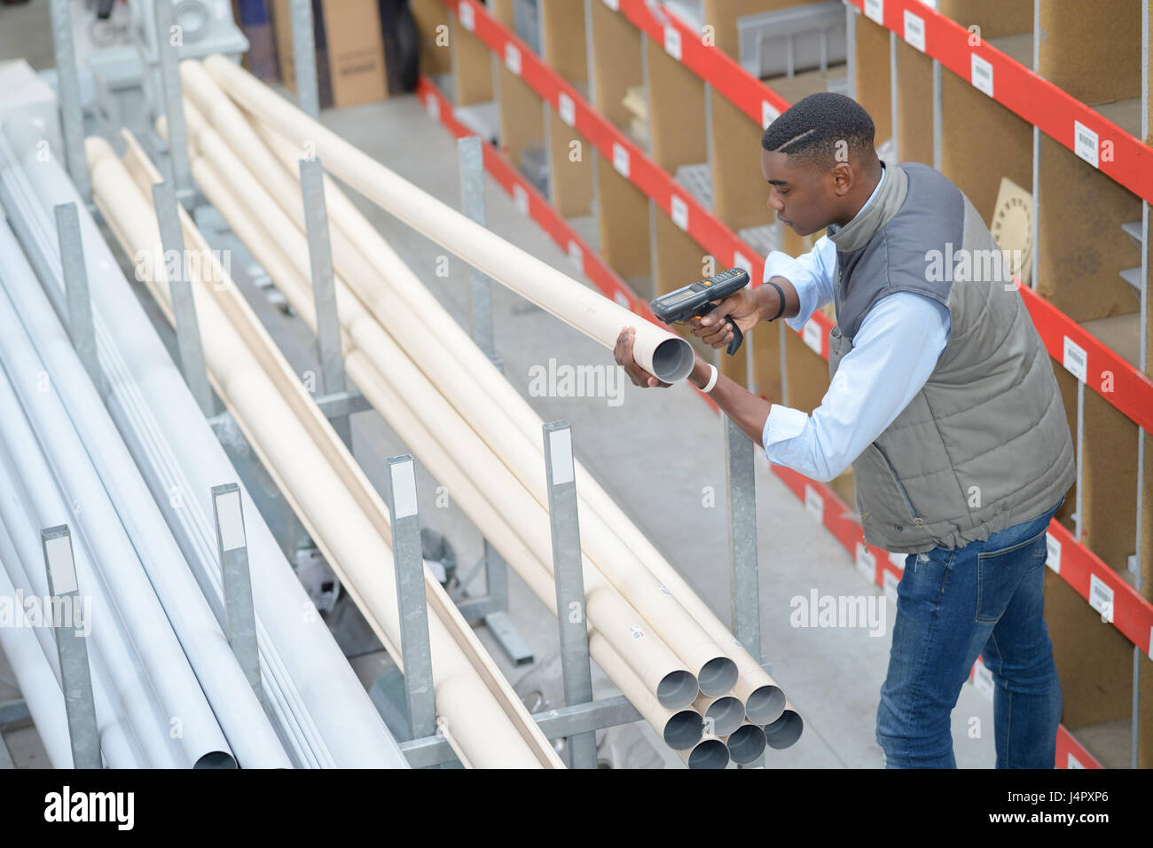 Man scanning plastic tubes in store Stock Photo - Alamy