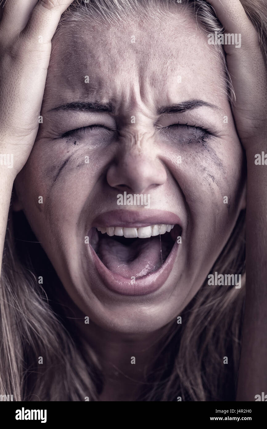 Closeup of a young woman desperately crying Stock Photo