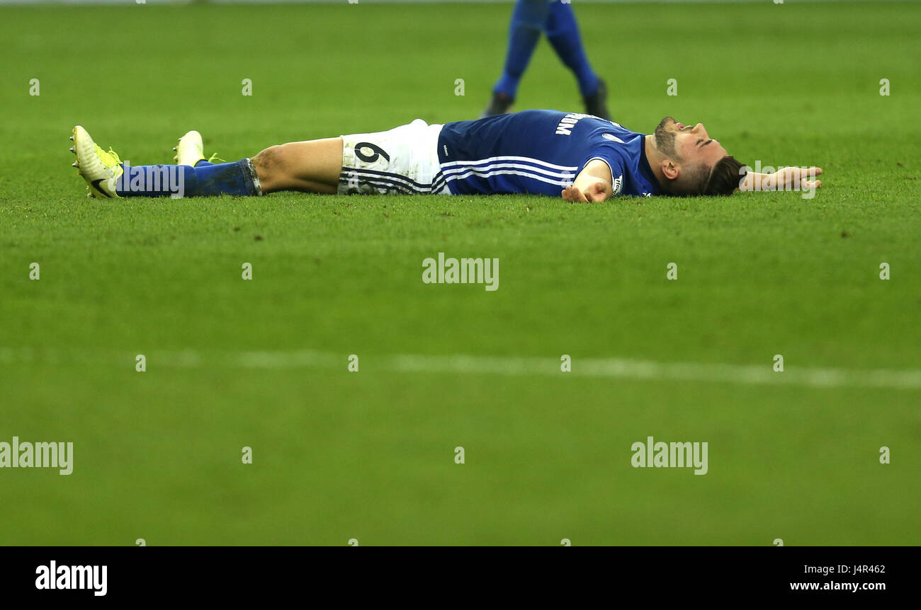 Gelsenkirchen, Germany. 13th May, 2017. Schalke's Sead Kolasinac lies on the ground after the German Bundesliga soccer match between FC Schalke 04 and Hamburger SV at the Veltins Arena in Gelsenkirchen, Germany, 13 May 2017. The match ended 1-1. (EMBARGO CONDITIONS - ATTENTION: Due to the accreditation guidelines, the DFL only permits the publication and utilisation of up to 15 pictures per match on the internet and in online media during the match.) Photo: Ina Fassbender/dpa/Alamy Live News Stock Photo