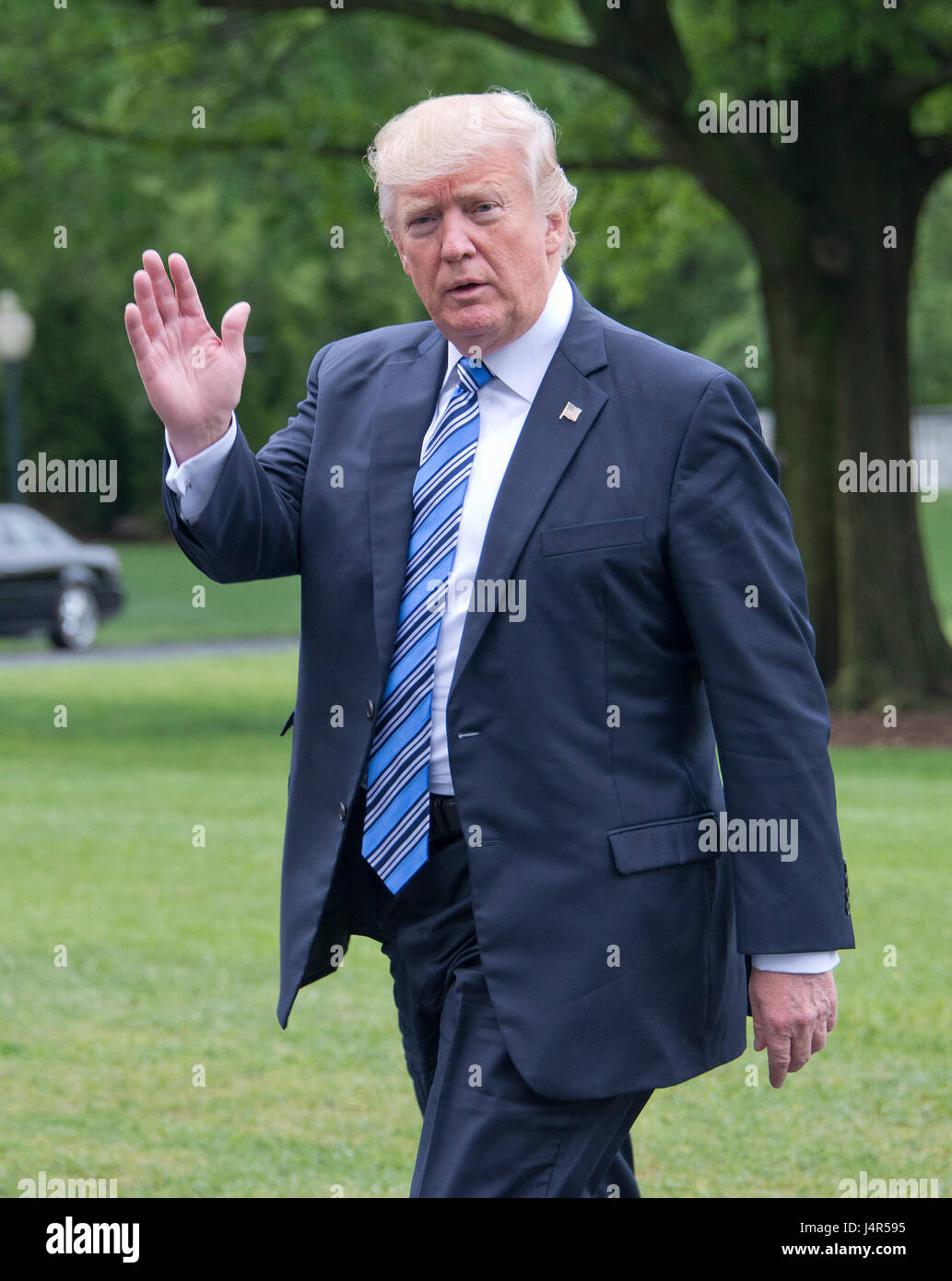 Washington DC, USA. 13th May, 2017. United States President Donald J. Trump waves to the press as he walks on the South Lawn of the White House in Washington, DC after traveling to Lynchburg, Virginia to make remarks at the Liberty University Commencement ceremony on Saturday, May 13, 2017. Credit: Ron Sachs/Pool via CNP /MediaPunch Credit: MediaPunch Inc/Alamy Live News Stock Photo
