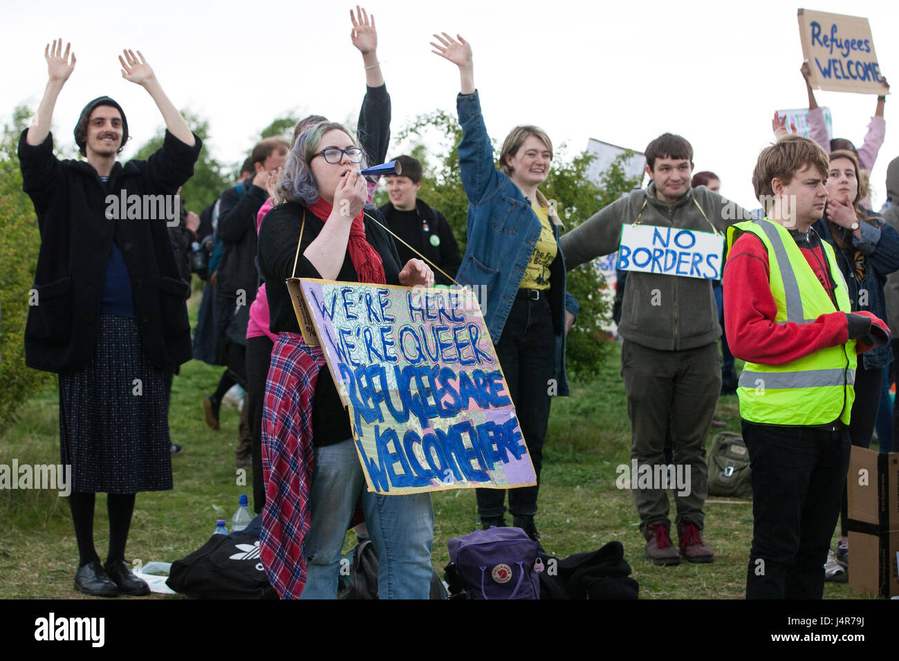 Milton Ernest, UK. 13th May, 2017. Campaigners against immigration detention communicate with detainees inside Yarl's Wood Immigration Removal Centre during a large protest organised by Movement For Justice By Any Means Necessary. Campaigners, including former detainees, called for all immigration detention centres to be closed. Credit: Mark Kerrison/Alamy Live News Stock Photo
