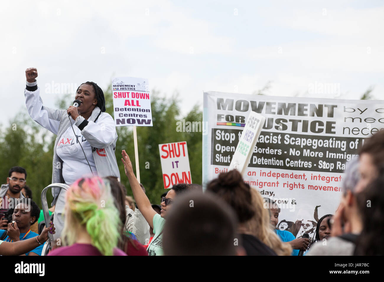 Milton Ernest, UK. 13th May, 2017. Mabel Gawanas, who was detained for almost three years at Yarl's Wood Immigration Removal Centre, addresses over a thousand campaigners against immigration detention attending a protest organised by Movement For Justice By Any Means Necessary outside the detention centre. Campaigners, including former detainees, called for all immigration detention centres to be closed. Credit: Mark Kerrison/Alamy Live News Stock Photo