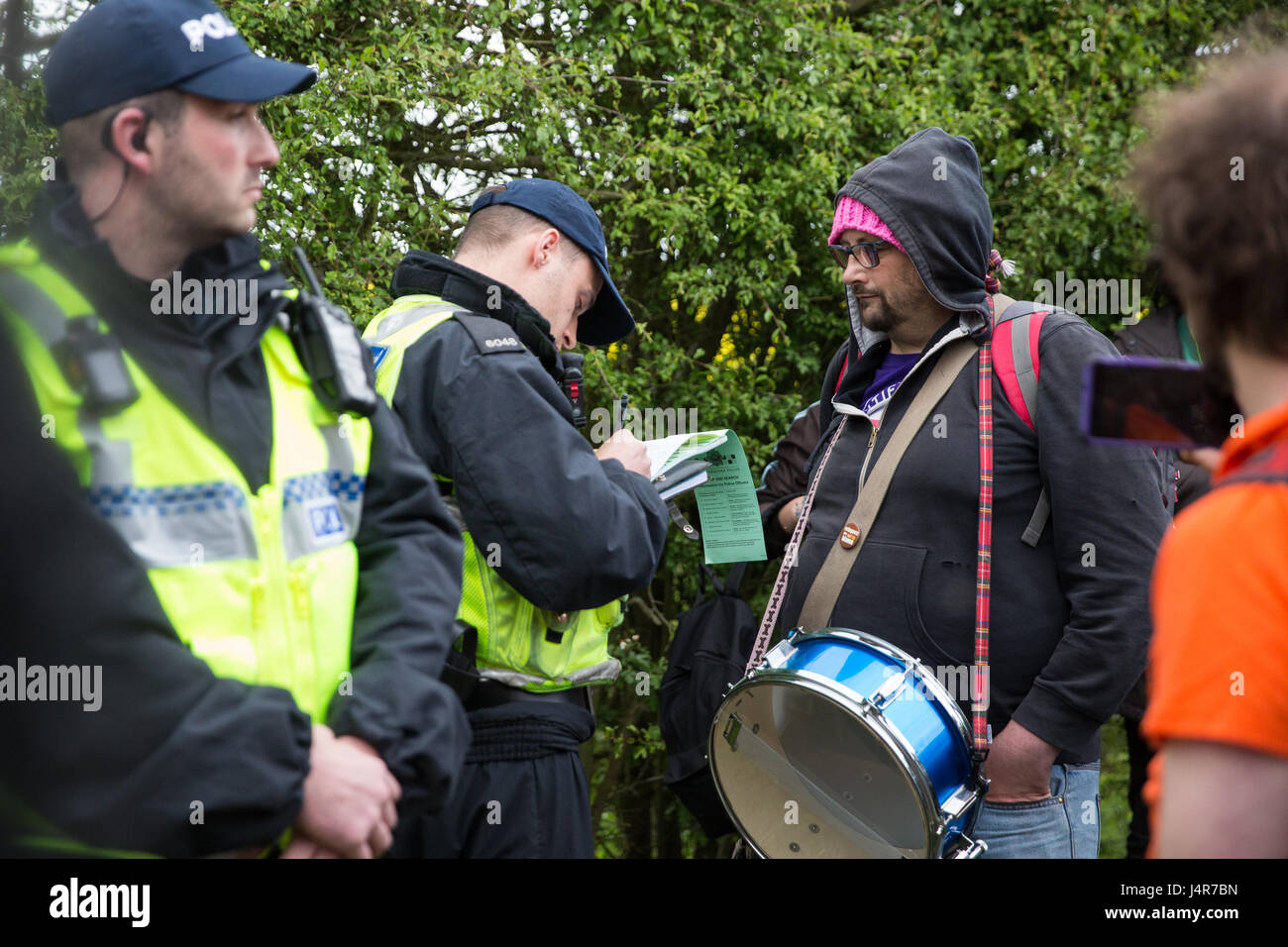 Milton Ernest, UK. 13th May, 2017. Police take down the details of a campaigner against immigration detention following a protest organised by Movement For Justice By Any Means Necessary outside Yarl's Wood Immigration Removal Centre. Campaigners, including former detainees, called for all immigration detention centres to be closed. Credit: Mark Kerrison/Alamy Live News Stock Photo