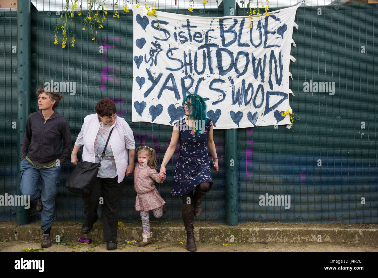 Milton Ernest, UK. 13th May, 2017. Campaigners against immigration detention kick the perimeter fence of Yarl's Wood Immigration Removal Centre during a protest organised by Movement For Justice By Any Means Necessary. Campaigners, including former detainees, called for all immigration detention centres to be closed. Credit: Mark Kerrison/Alamy Live News Stock Photo