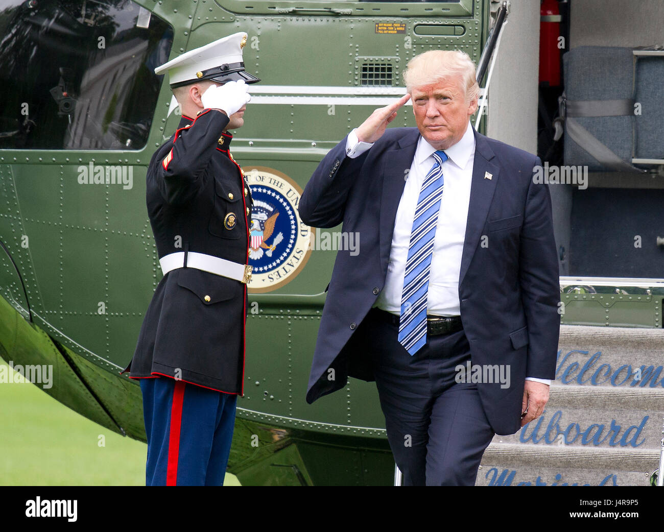 United States President Donald J. Trump salutes the Marine Guard as he