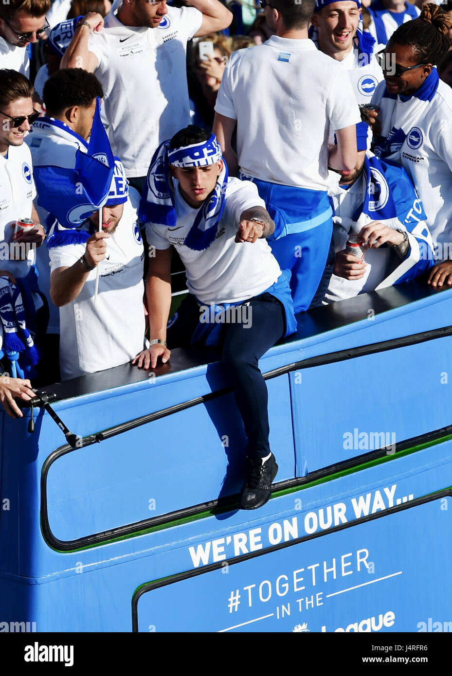 Brighton, UK. 14th May, 2017. Thousands of fans line Brighton seafront to watch the Brighton and Hove Albion football club bus parade to celebrate their promotion to the Premier League in beautiful sunny weather Credit: Simon Dack/Alamy Live News Stock Photo