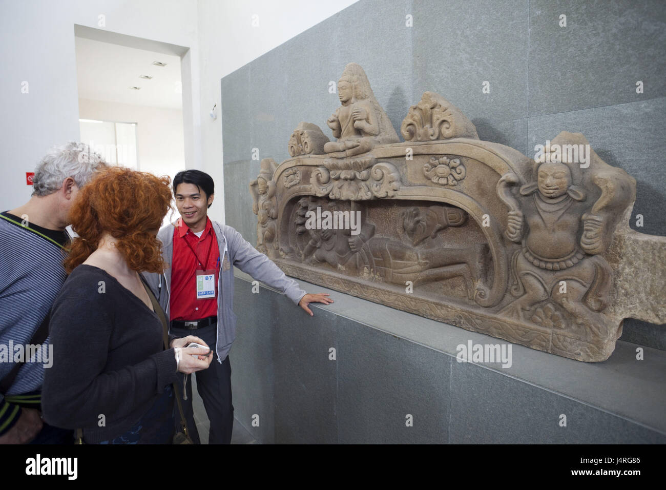 Vietnam, Danang, museum of the Cham sculpture, tourist, on the sandstone relief looking, no model release, Stock Photo