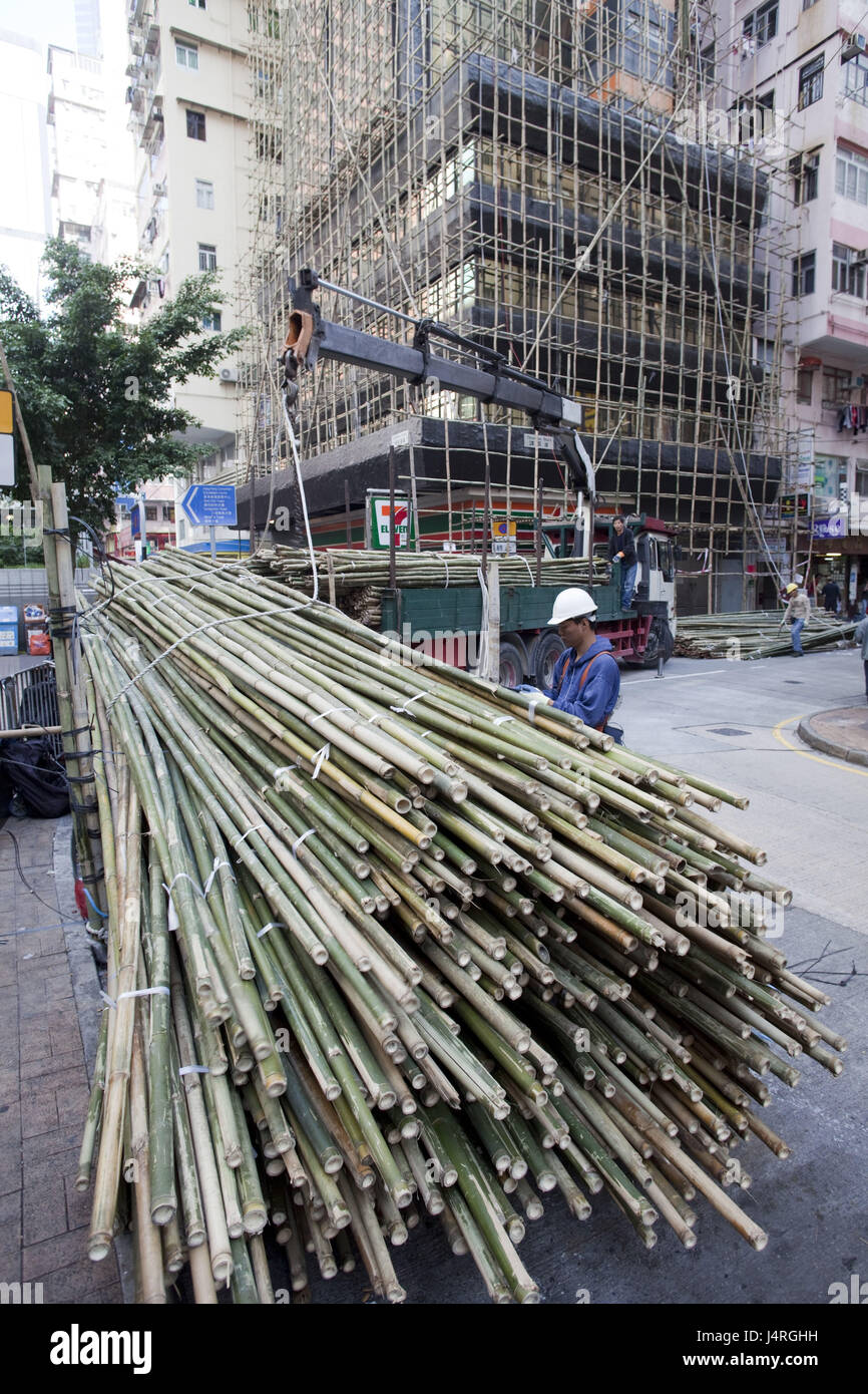 China, Hong Kong, men at work, worker, loaded, bamboo sticks, Stock Photo
