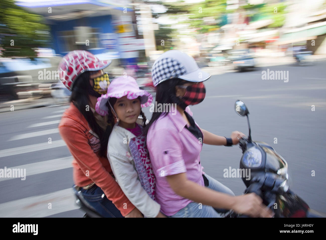Vietnam, Danang, motorcyclist, women, child, at the side, blur, no ...